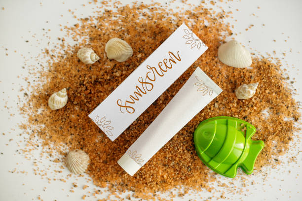 istock cosmetics sunscreen packaging on sand. Top view. Summer helper 697255594