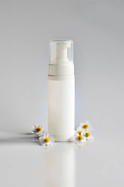 istock Cosmetic product for cream, foam, shampoo. on white background. With chamomile 697255704