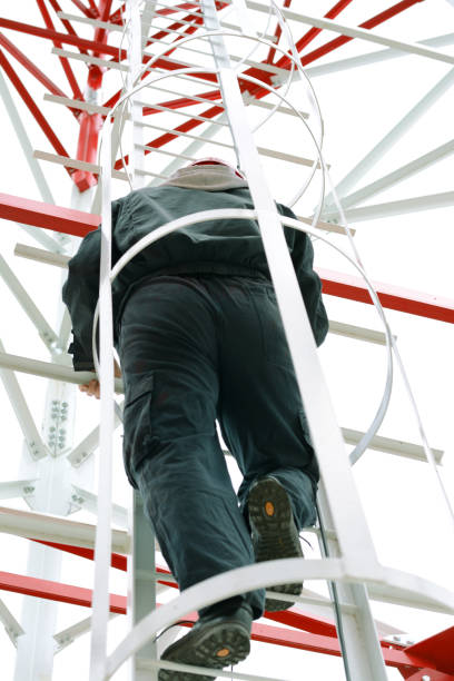 istock Man climbing a high power electric line tower 697257076
