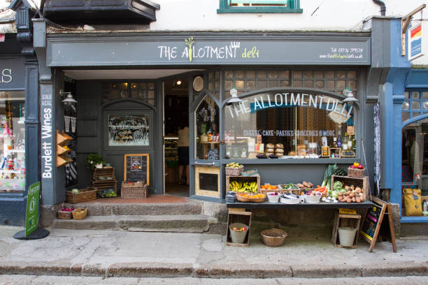 The Allotment Deli Facade St Ives, Cornwall, UK - April 18, 2017. The facade and shop window of a local store called The Allotment Deli which sells locally grown produce to local people and tourists in St Ives, Cornwall, UK. community garden sign stock pictures, royalty-free photos & images