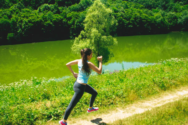 istock Woman running in nature 697268082