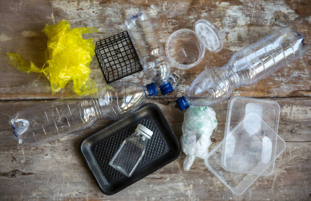 empty plastic bags, containers, bottles empty plastic containers, bags and bottles on a rustinc kitchen table disposable photos stock pictures, royalty-free photos & images