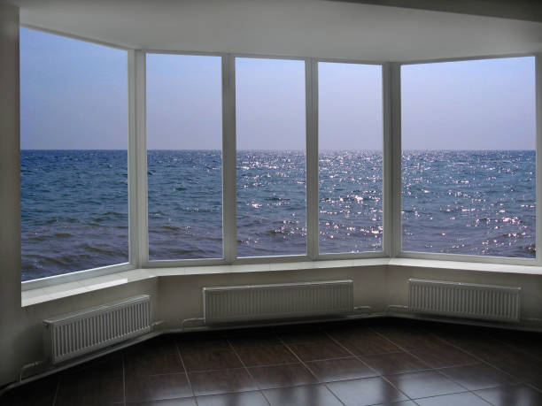 istock big office windows with view of marine waves 697281710