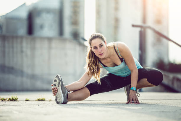 istock Female Athlete Stretching Outdoors 697288438