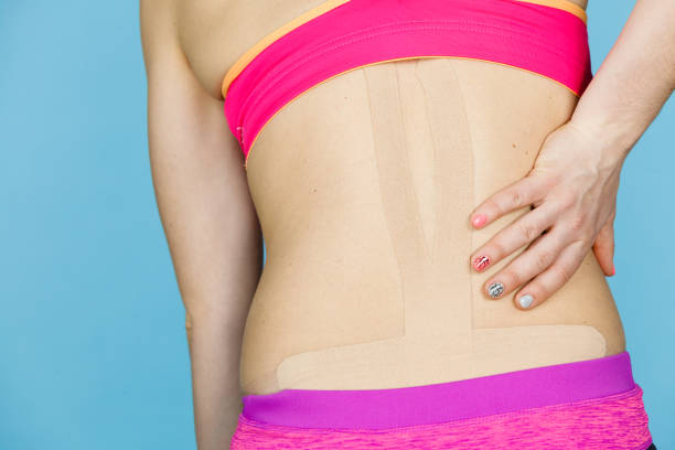 istock Woman with medical kinesio taping on back 697298672