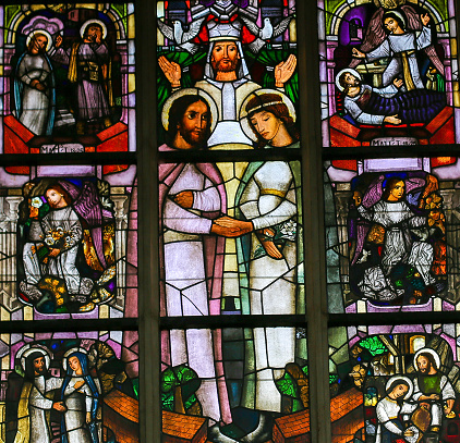 ANTWERP, BELGIUM - APRIL 30, 2017: Stained Glass window in the Church of Saint Andrew in Antwerp, Belgium, depicting the Sacrament of Holy Matrimony