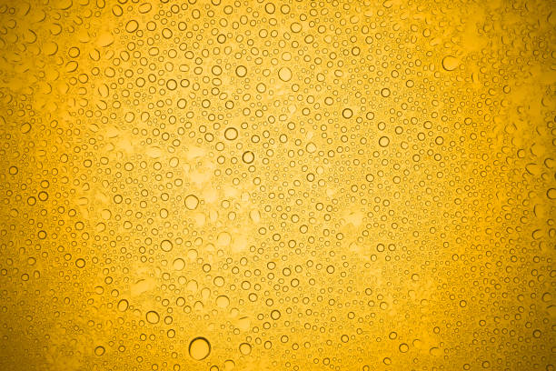 istock Water drops on yellow glass, Rain droplets on glass background. 697301800