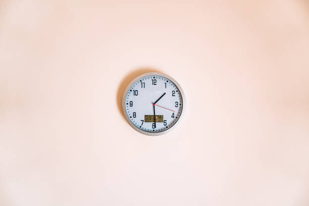 istock Wall clock in the apartment with a thermometer and weather forec 697301860