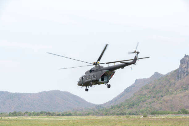 istock Helicopter in flight. Fly over the mountain and blue sky. 697302036