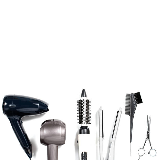 istock Various hair styling devices on white background, top view 697305564