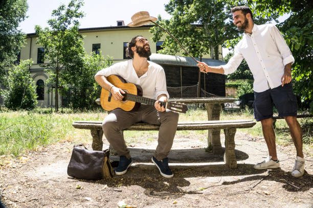 istock Two adult men playing guitar and having fun 697308642