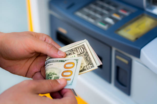 istock taking money out of the ATM 697308652