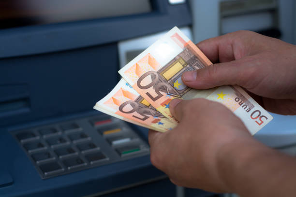 istock taking money out of the ATM 697308718