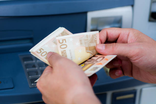 istock taking money out of the ATM 697308720