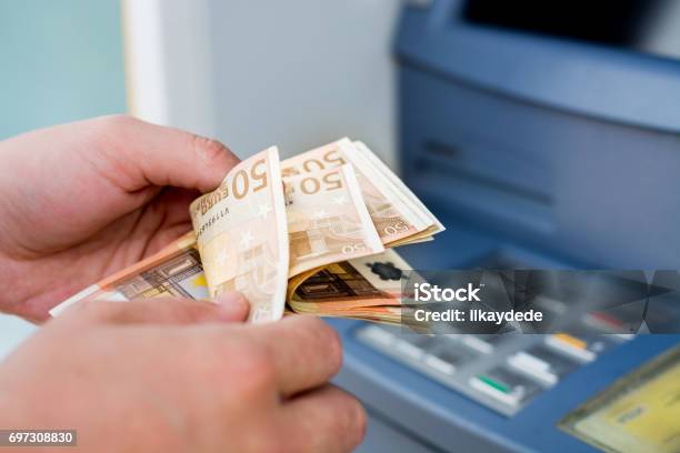 Taking Money Out Of The Atm Stock Photo - Download Image Now - ATM, European Union Currency, Paper Currency