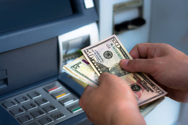 istock taking money out of the ATM 697308924