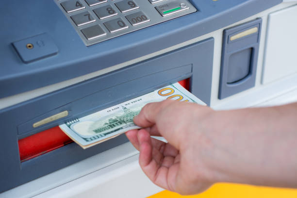 istock taking money out of the ATM 697309192