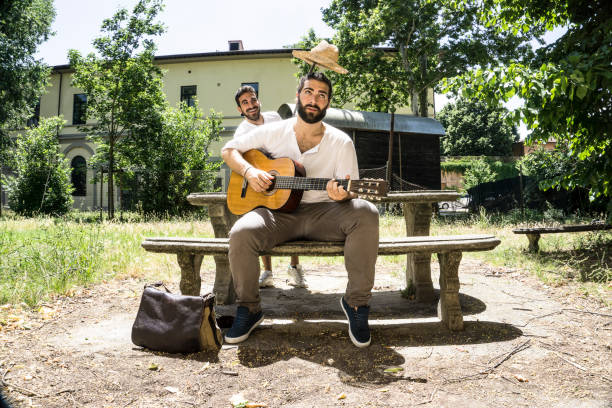 istock Two adult men playing guitar and having fun 697310260