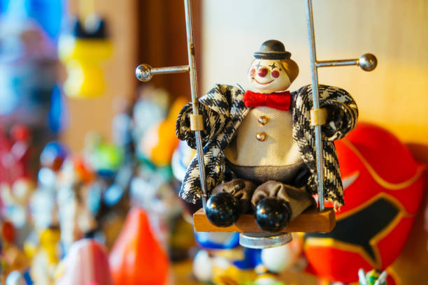 istock Clown doll sitting on a swing. 697310336
