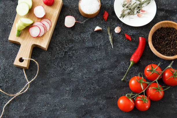 istock Composition of green and red vegetables on a dark background with space for text. 697316296