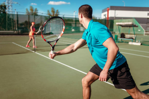 istock Athletic man and slim woman on tennis training 697329908