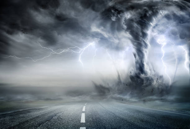 Powerful Tornado On Road In Stormy Landscape Twister In Storm - Gray landscape tornado stock pictures, royalty-free photos & images