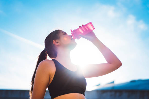 istock Female athlete drinking from sports bottle 697333468