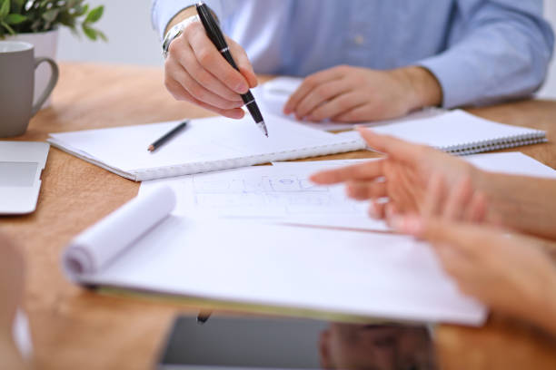 istock Hands of business people meeting around table 697342792