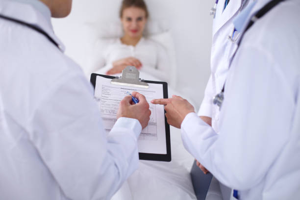 istock A group of doctors discussing medical history close up 697343304