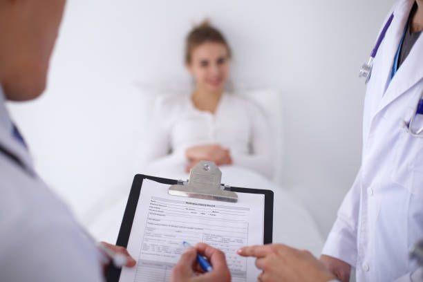 istock A group of doctors discussing medical history close up 697343334