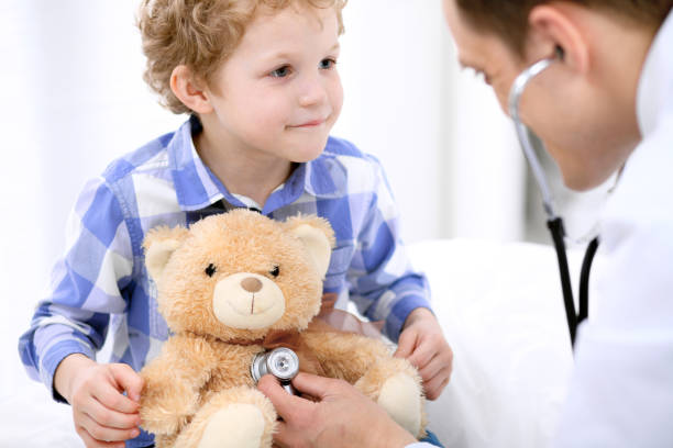istock Doctor examining a child  patient by stethoscope 697343630