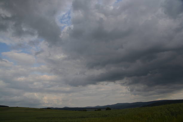 istock Clouds move across the country 697347636