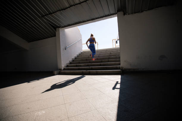 istock Woman running up the stairs 697348016