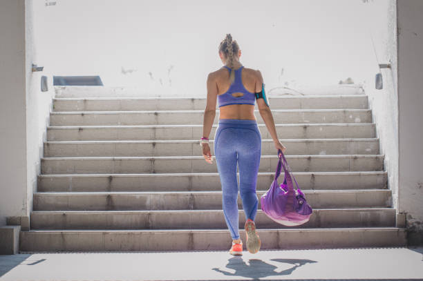 Female athlete Young women in sports clothing walking up the stairs leggings stock pictures, royalty-free photos & images