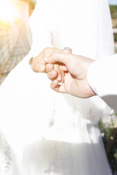 istock The bride leads the groom's hand behind her. Wedding. 697359514