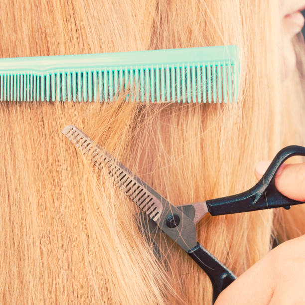 istock Woman cutting down smoothy hair. 697362402