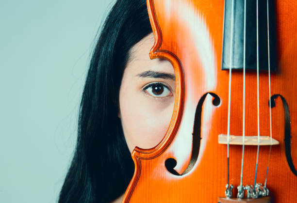 Portrait of young woman with musician friends outdoors