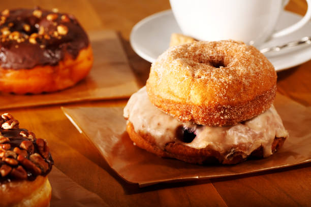istock Donuts with coffee on a rustic wooden background 697364958