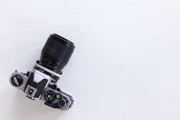 istock vintage camera on wooden table. Top view. Free space 697365670