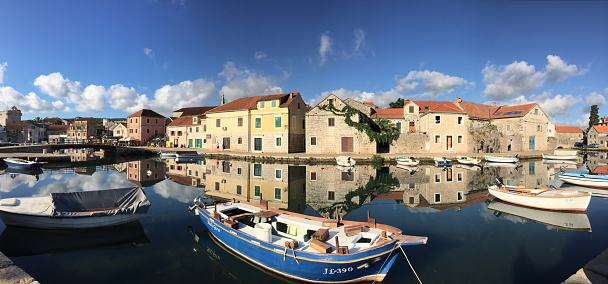 Vrboska, Croatia - June 20, 2016: Panoramic view of traditional Dalmatian fishing village and marina early in the morning, Hvar Island, Dalmatia, Croatia.  Vrboska is an ideal destination for those who are looking to benefit from the rich monumental heritage and natural beauties of Central Dalmatia islands.
