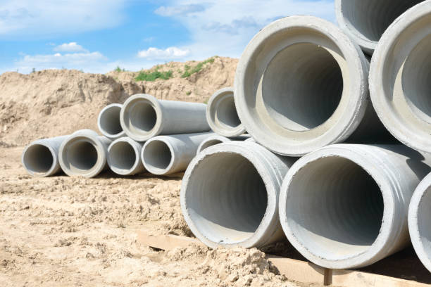 istock Industrial concrete drainage pipes stacked for construction. New tubes 697369372