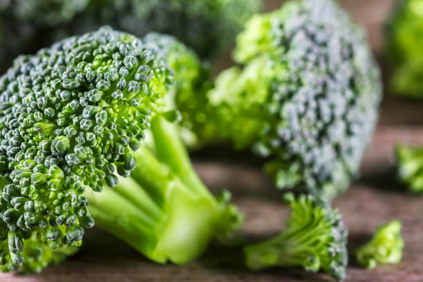 istock Pieces of broccoli, rustic style, old wooden background 697371736