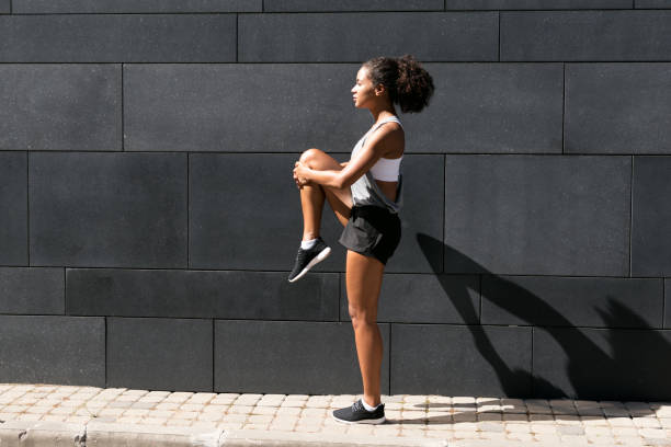 istock Side view of female athlete stretching leg 697375554