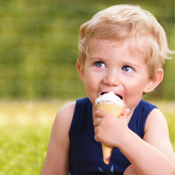 istock toddler infant boy eat ice cream 697378366