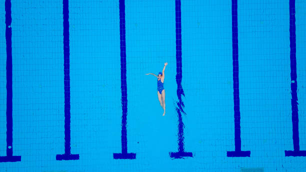 istock High angle view on swimming pool and female swimmer 697383780