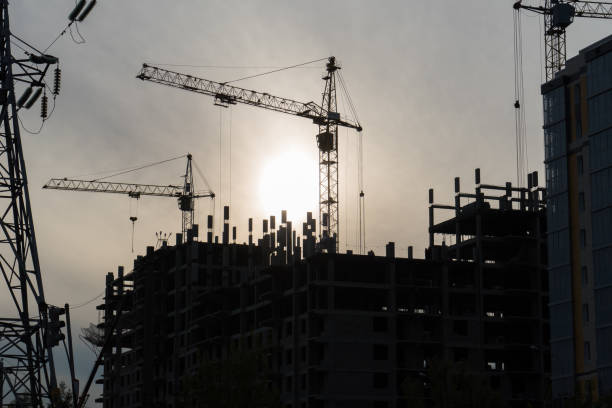istock Tower crane work, in the evening on the construction site 697393154