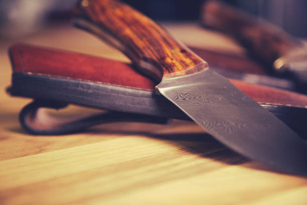 Close up of custom made Damascus knife. Hunting knife with leather case.