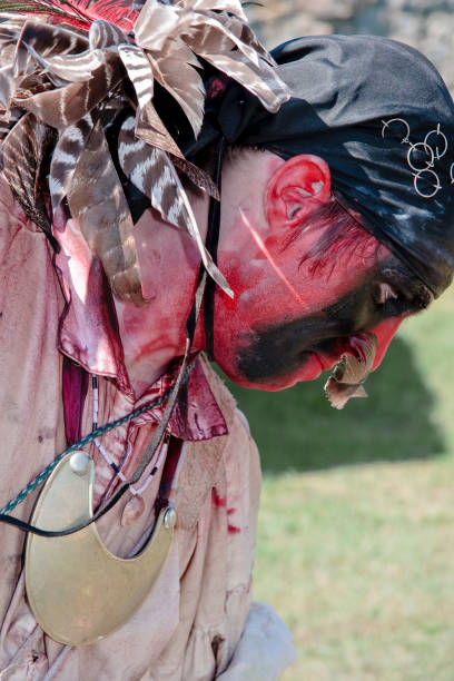 A reenactor portraying a Cherokee Indian during the French and Indian War in North America.  This was a war fought between Great Britain and France in North America from 1754 to 1763.  In Canada, this war might be referred to as the Seven Years' War, although French speakers in Quebec often call it La guerre de la Conquête (\