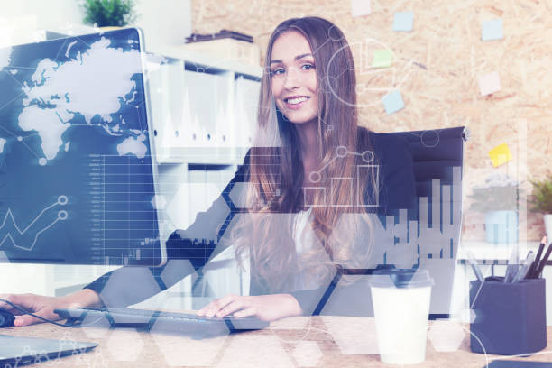 istock Smiling businesswoman at a computer, toned 697393430