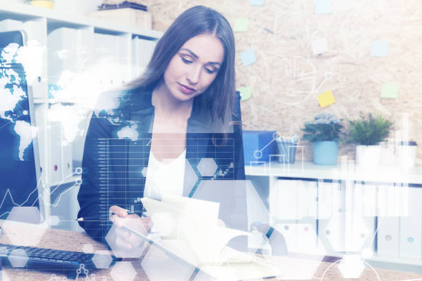 istock Woman on phone in office, graphs 697393766